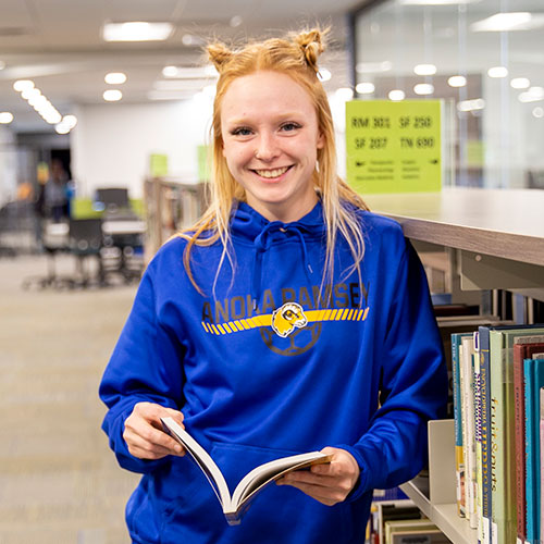 Hannah Brunes class 2022
Integrative Health and Healing certificate graduate standing in library with book.
